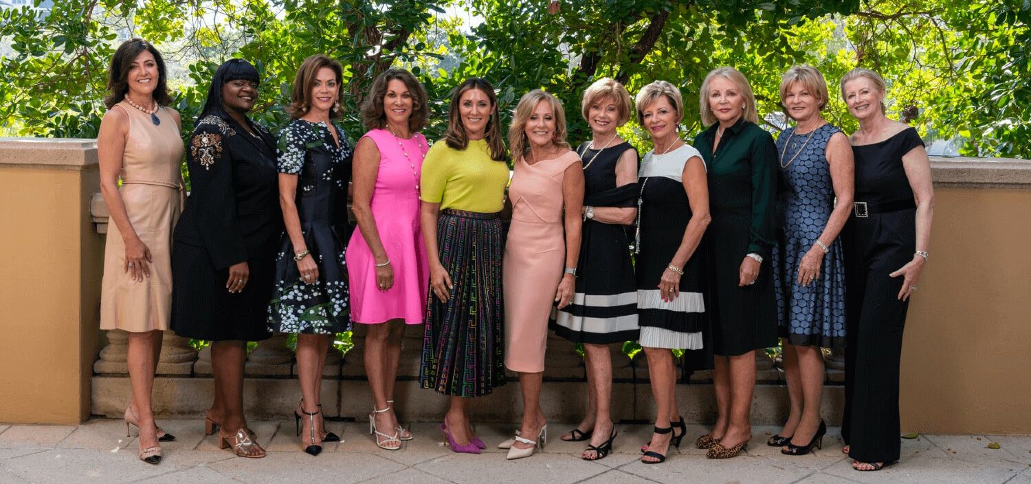 group of women dress nicely smiling