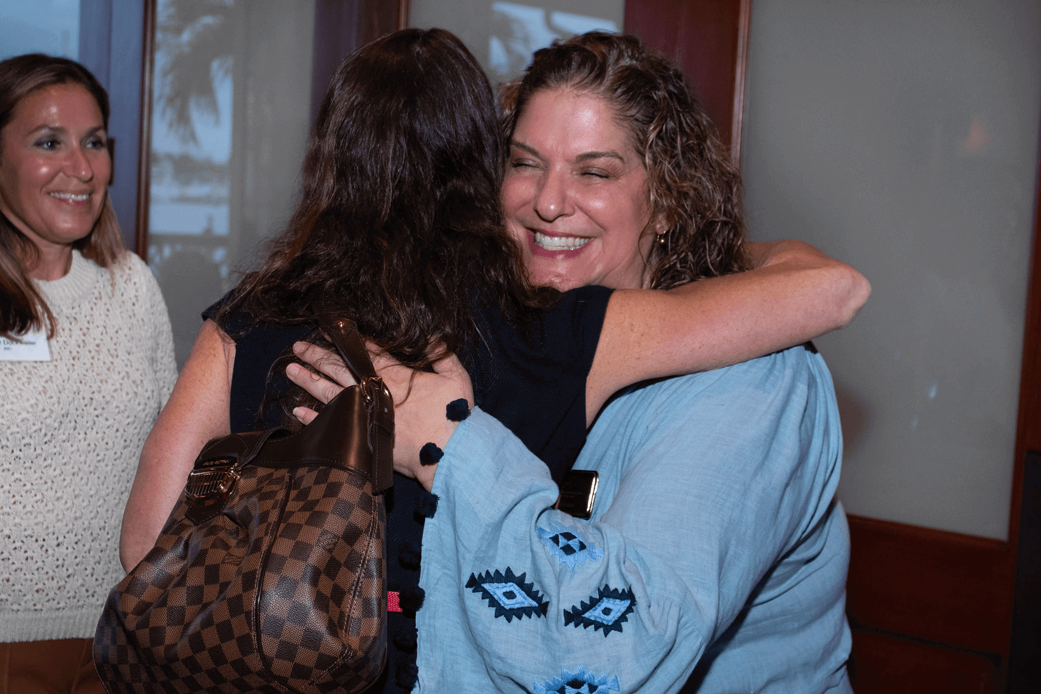 women smiling and hugging